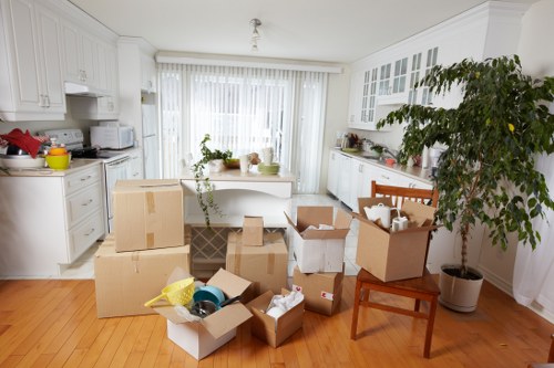 Packed moving boxes and furniture prepared for transport in a local flat move