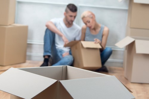 Commercial relocation setup with labelled boxes and office furniture in St Johns Wood